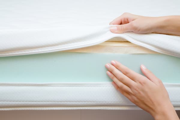 Mattress layers A person revealing mattress layers