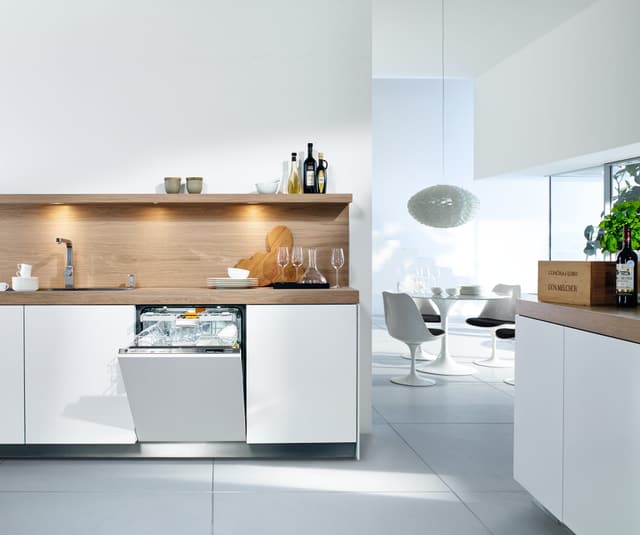 View of a modern kitchen with an opened Miele dishwasher