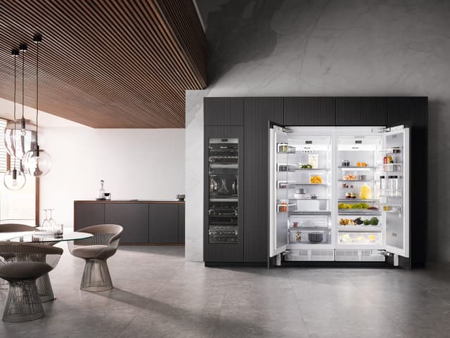 Front view of a luxury kitchen with an opened Miele refrigerator