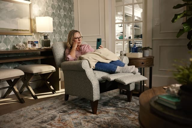 Front view of a woman relaxing in a La-Z-Boy recliner Front view of a woman relaxing in a La-Z-Boy recliner