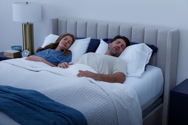Front view of a couple sleeping on a tempur pedic mattress Front view of a couple sleeping on a tempur pedic mattress